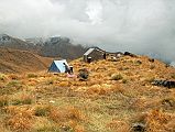 303 Camp On Top Of The Ridge We stopped at 11:00 for a lunch of bread, yak cheese and cold potatoes, and left again at 11:30. We continued our rolling descent, arriving at our camp spot (4500m) at 13:00. The temperature dropped below freezing, and it snowed. When I went to bed at 19:20 the snow had stopped and the weather was clear.